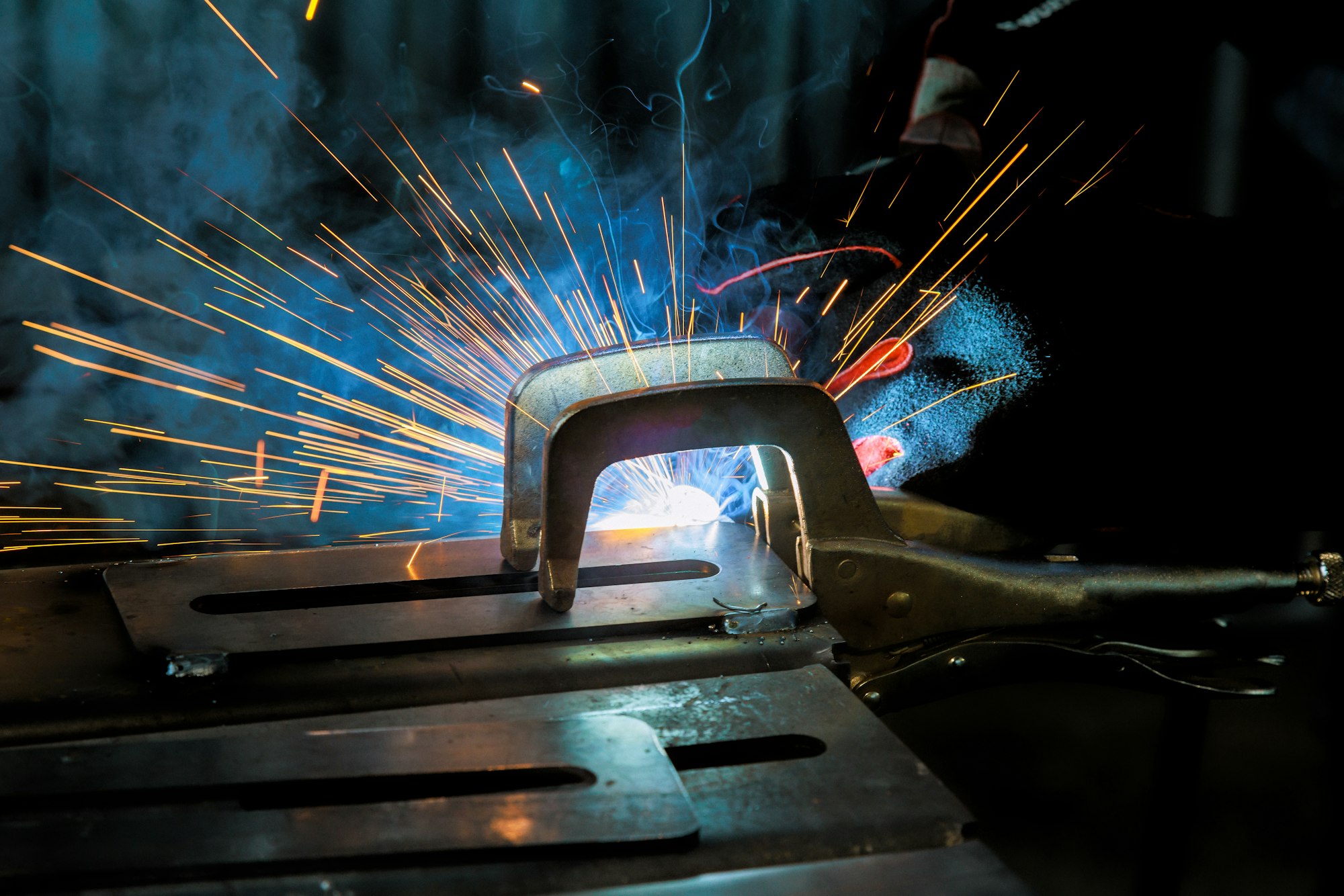 Professional welder specializes in conducting welding operations with semi-automatic argon arc