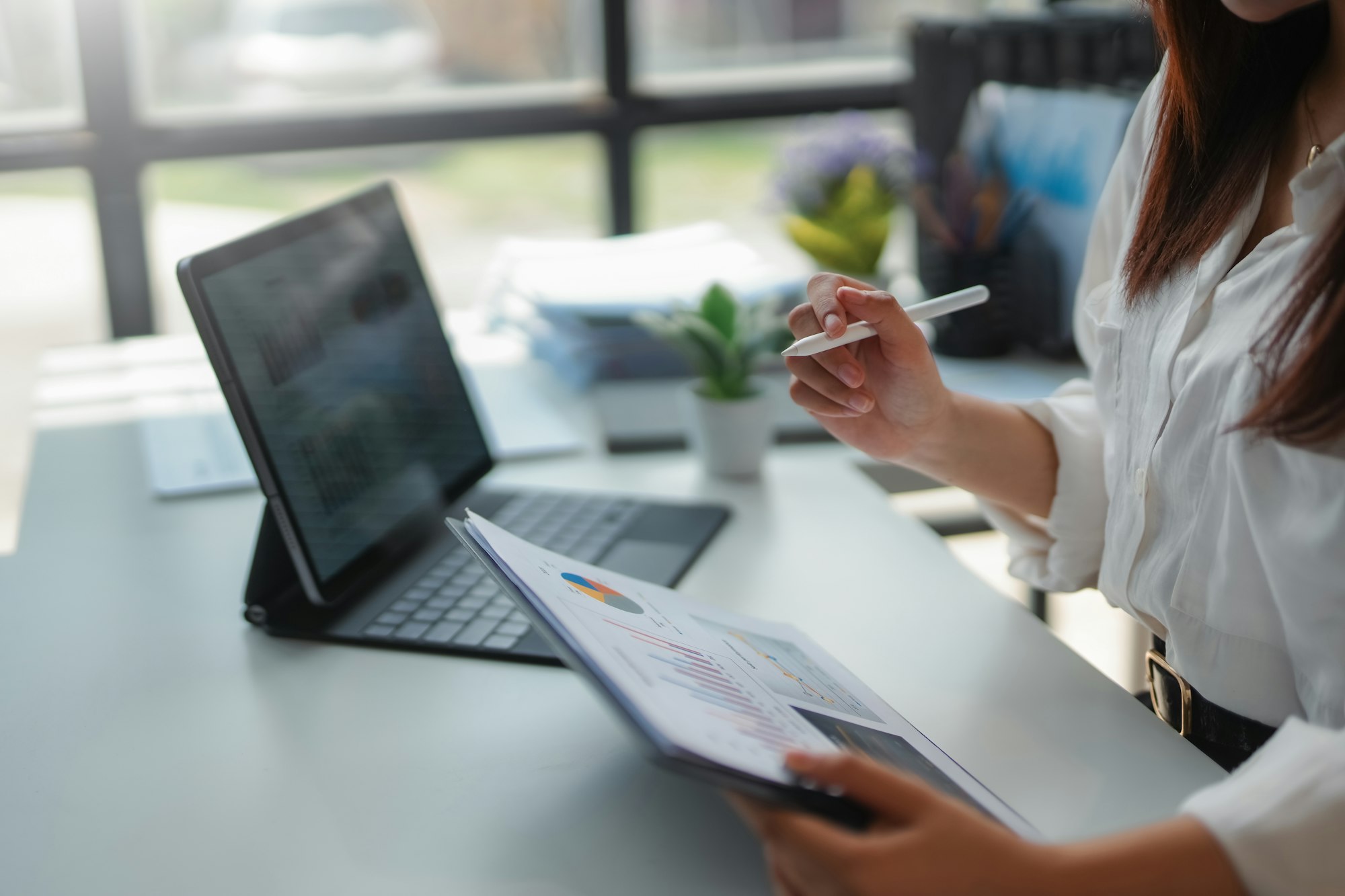 Businesswoman analyzing financial charts and data on a report